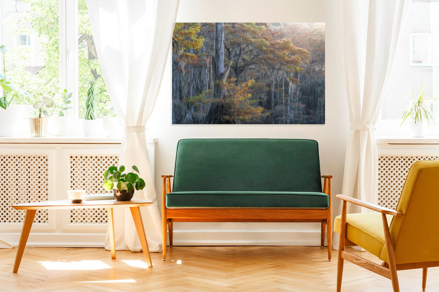 Living room with green sofa, yellow chair, and a large photo print on the wall.