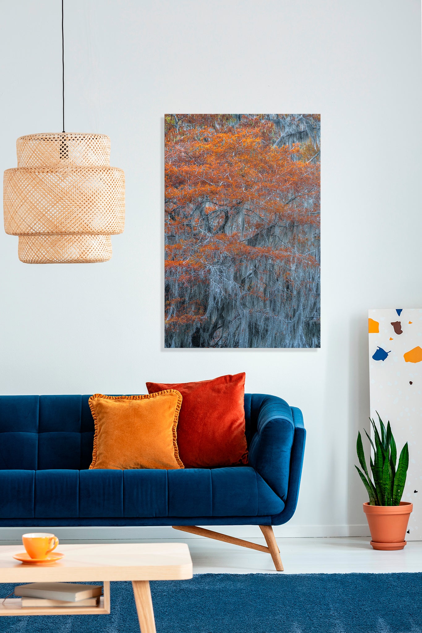 Living room with a blue sofa, colorful pillows, and abstract art on the wall.