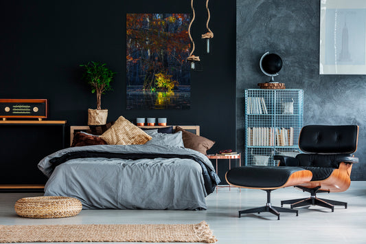 Modern bedroom with dark walls, a bed, and stylish furniture.