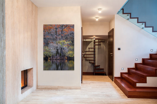 Modern interior with a fireplace, artwork, and staircase.
