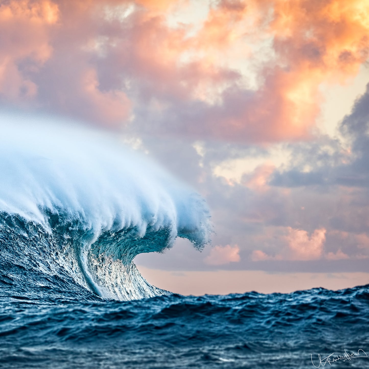 Large ocean wave with a colorful sky during sunset