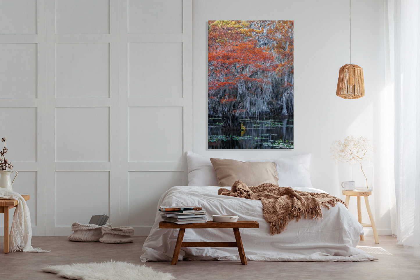 Modern bedroom with a bed, side tables, and a large photograph.