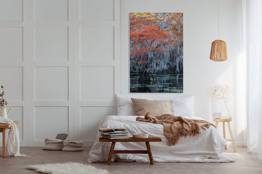 Modern bedroom with a bed, side tables, and a large photograph.