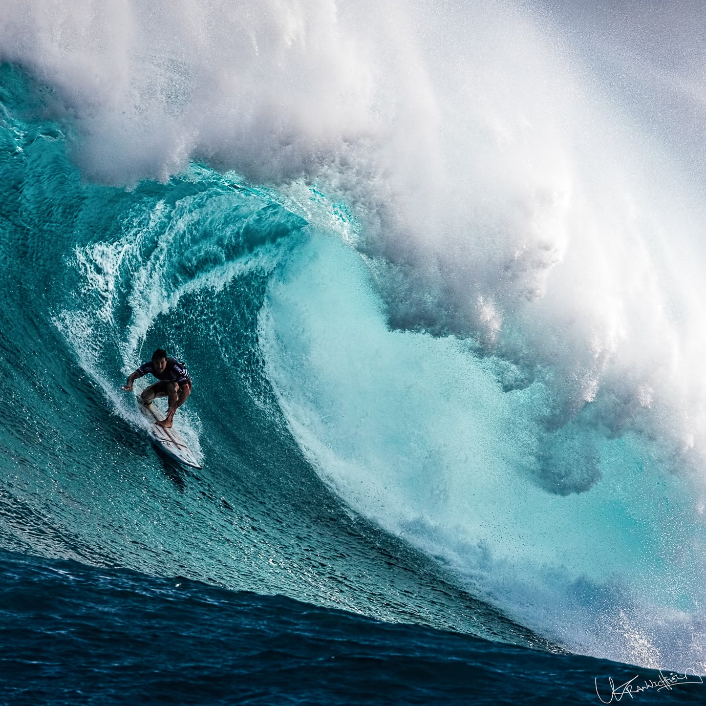 Surfer riding a large wave in the ocean