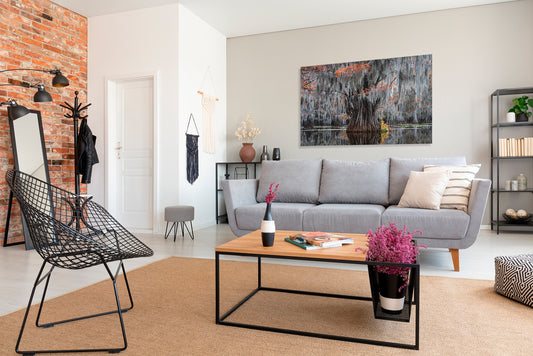 Modern living room with gray sofa, coffee table, and decorative items.