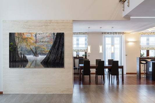 Modern interior with a large wall art piece depicting a forest scene.