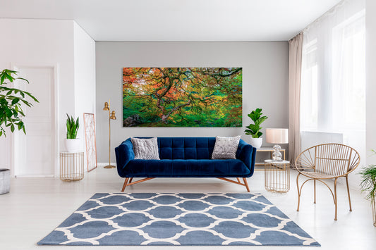 Modern living room with a blue sofa, patterned rug, and colorful wall art.