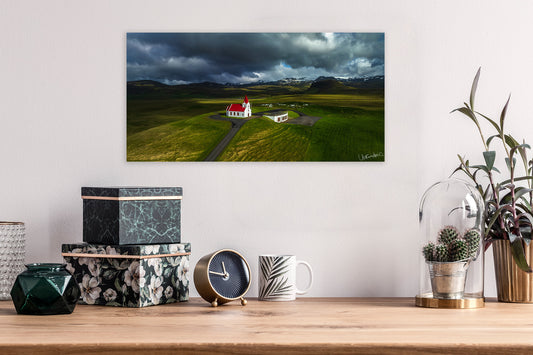 Scenic wall art above a wooden shelf with decorative items