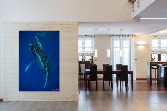 Dining room with a large vertical whale photo on the wall