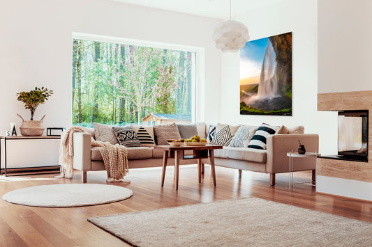 Modern living room with a large photograph of a waterfall, surrounded by decor elements.