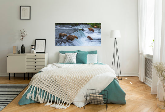 Bedroom with a large bed, dresser, and wall art of bears by a river.