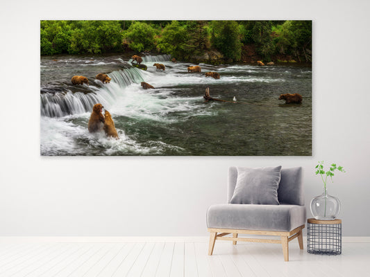 Wall art of bears fishing in a river with a waterfall, displayed above a modern living room setup.