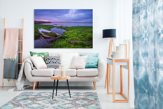 Living room with a white sofa, decorative pillows, and a large wall art of a nature scene.