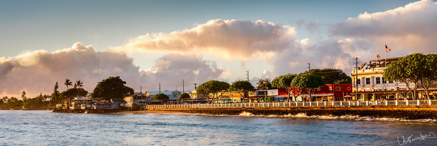 Panoramic view of Front St in Lahaina under a cloudy sky.