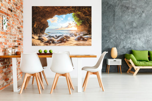 A large framed picture depicting a natural cave leading to a Maui beach scene, displayed on a wall in a room with modern furniture.