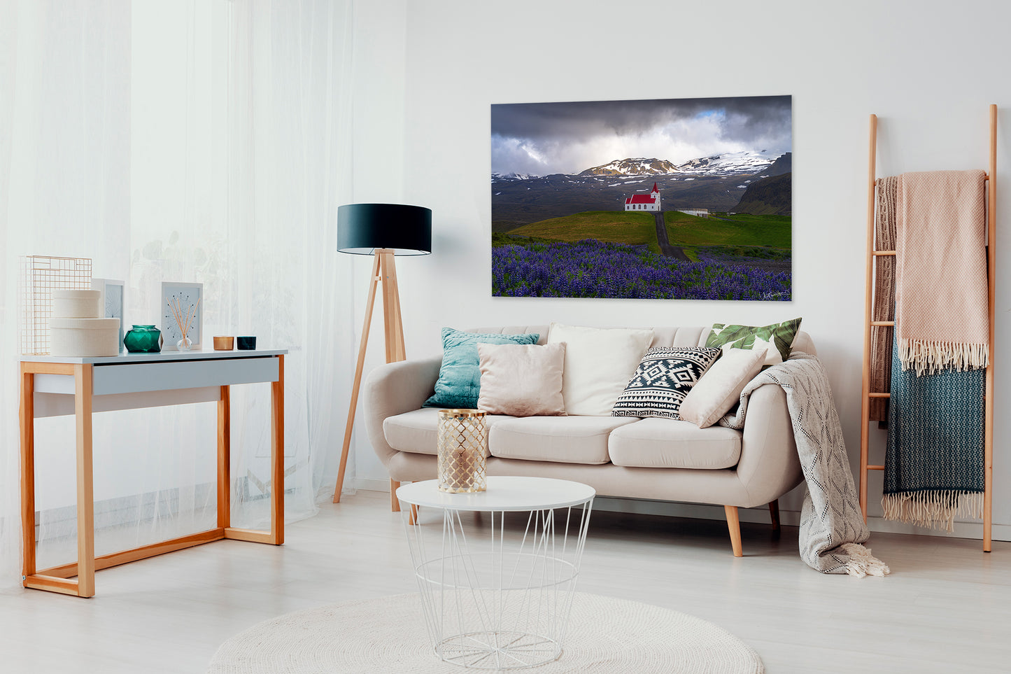 Modern living room with a sofa, coffee table, and a large photograph of Iceland.