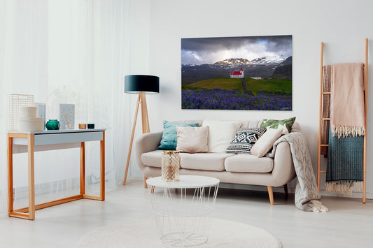 Modern living room with a sofa, coffee table, and a large photograph of Iceland.