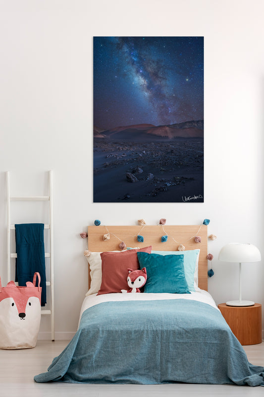Bedroom with a large photograph depicting a night sky over a mountainous landscape.