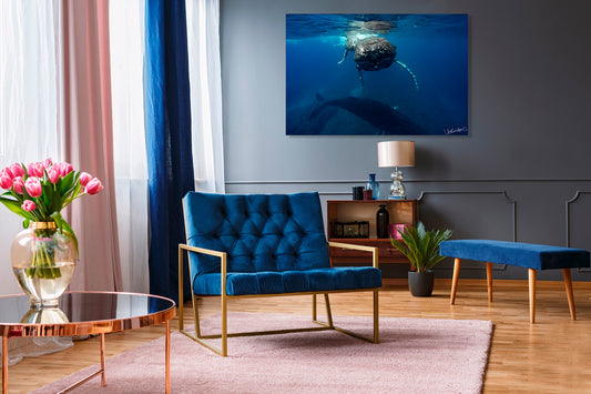 Modern living room with blue armchair, coffee table, and decorative elements.