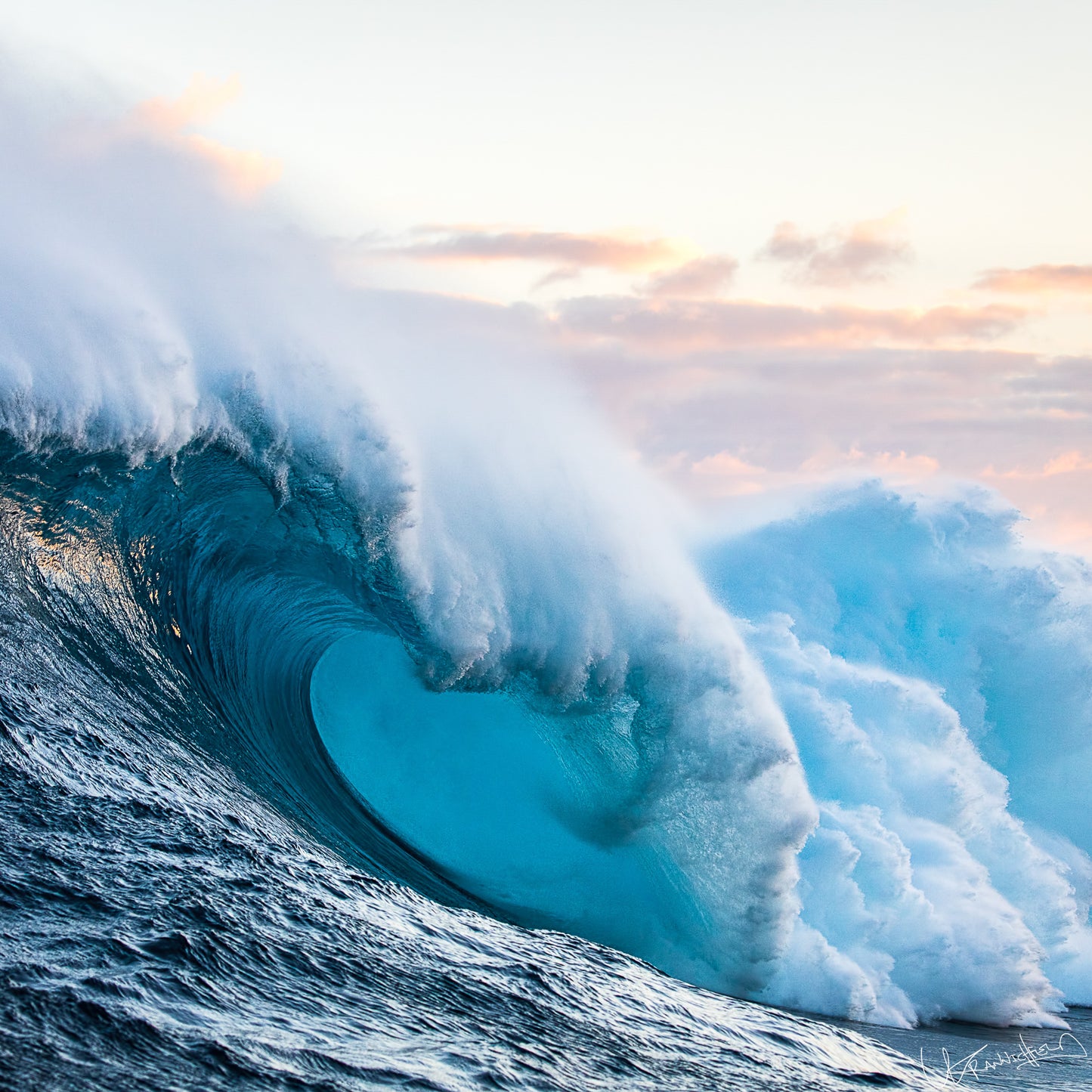 Powerful wave in the ocean with a colorful sky