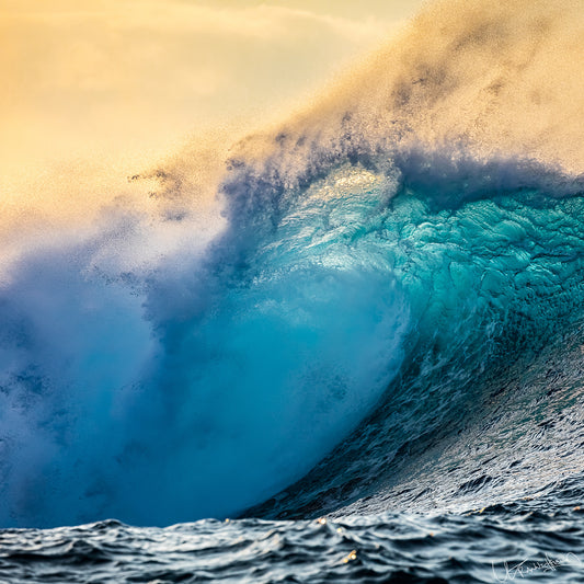 Powerful wave in the ocean with a yellowish sky.