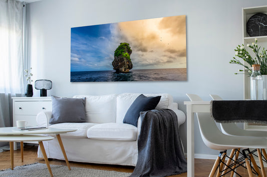 Living room with a large wall art photograph of a coastal scene.