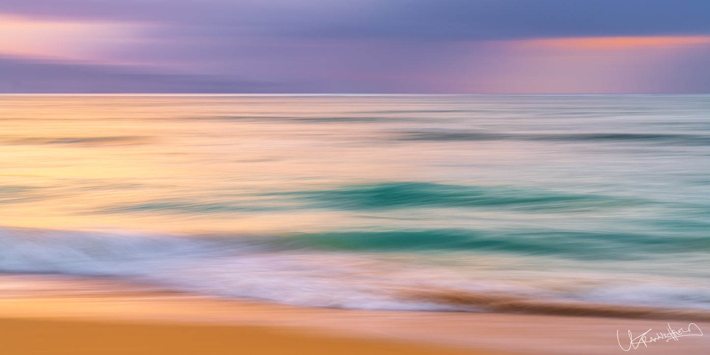 Abstract seascape with blurred waves and colorful sky at sunset.