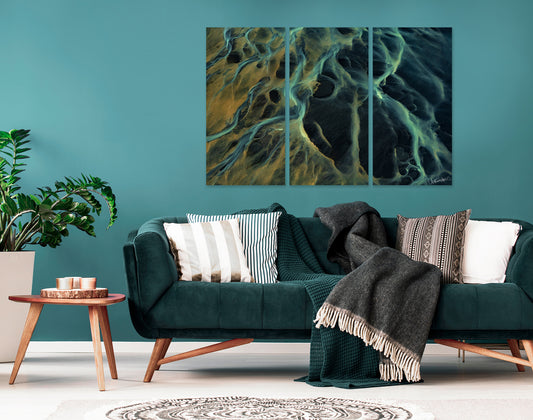 Living room with teal sofa, decorative pillows, and a large abstract triptych wall art piece.