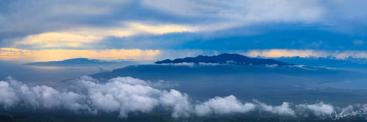 A panoramic image capturing a scenic view of clouds and mountains, taken from an elevated position near Haleakala National Park.