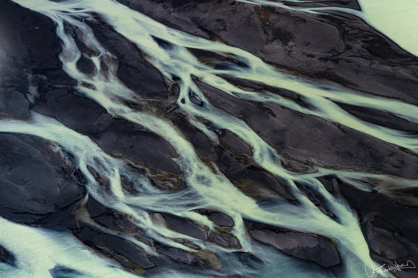 Close-up of river ice with dark water and light ice formations.
