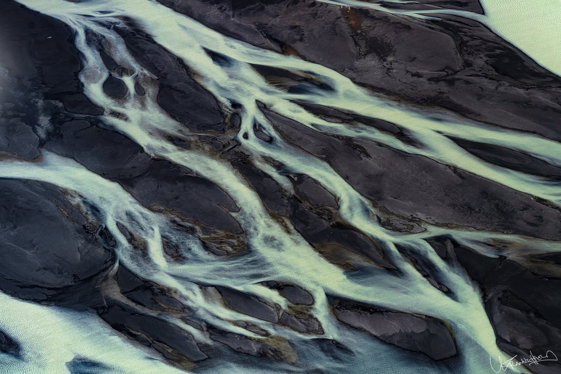 Close-up of river ice with dark water and light ice formations.