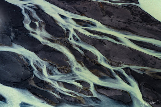 Close-up of river ice with dark water and light ice formations.