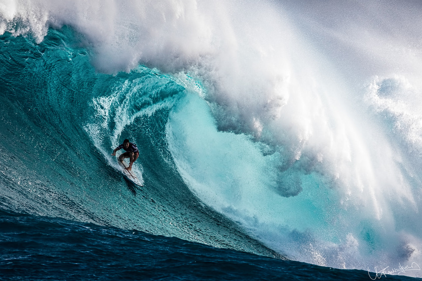Surfer riding a large wave in the ocean