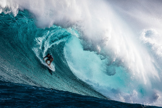 Surfer riding a large wave in the ocean