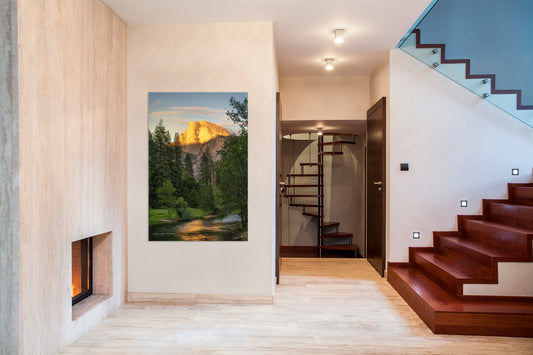 Modern interior with a fireplace, staircase, and scenic wall art.