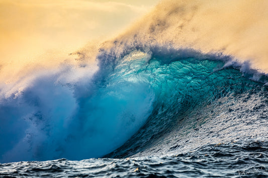 Large ocean wave with white foam against a yellowish sky