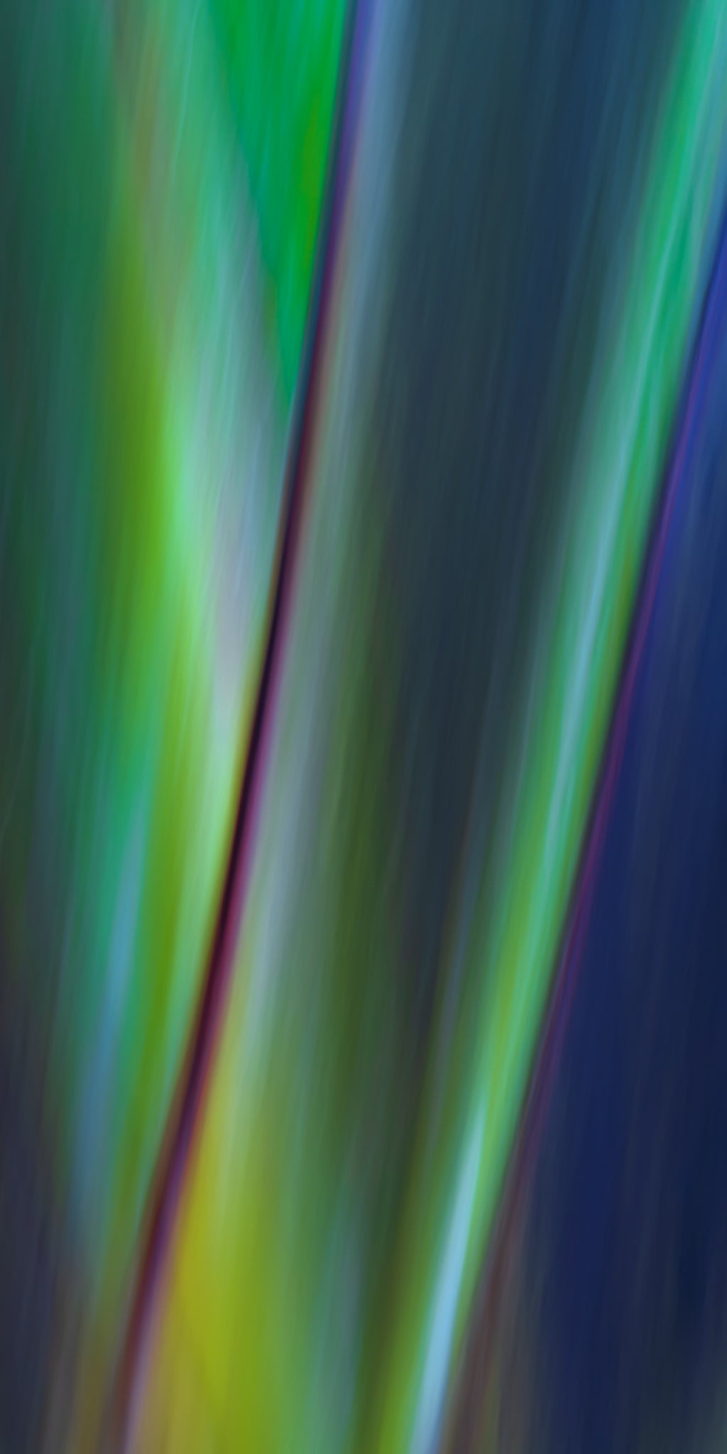 Colorful abstract pattern with vertical stripes in green, blue, and purple.