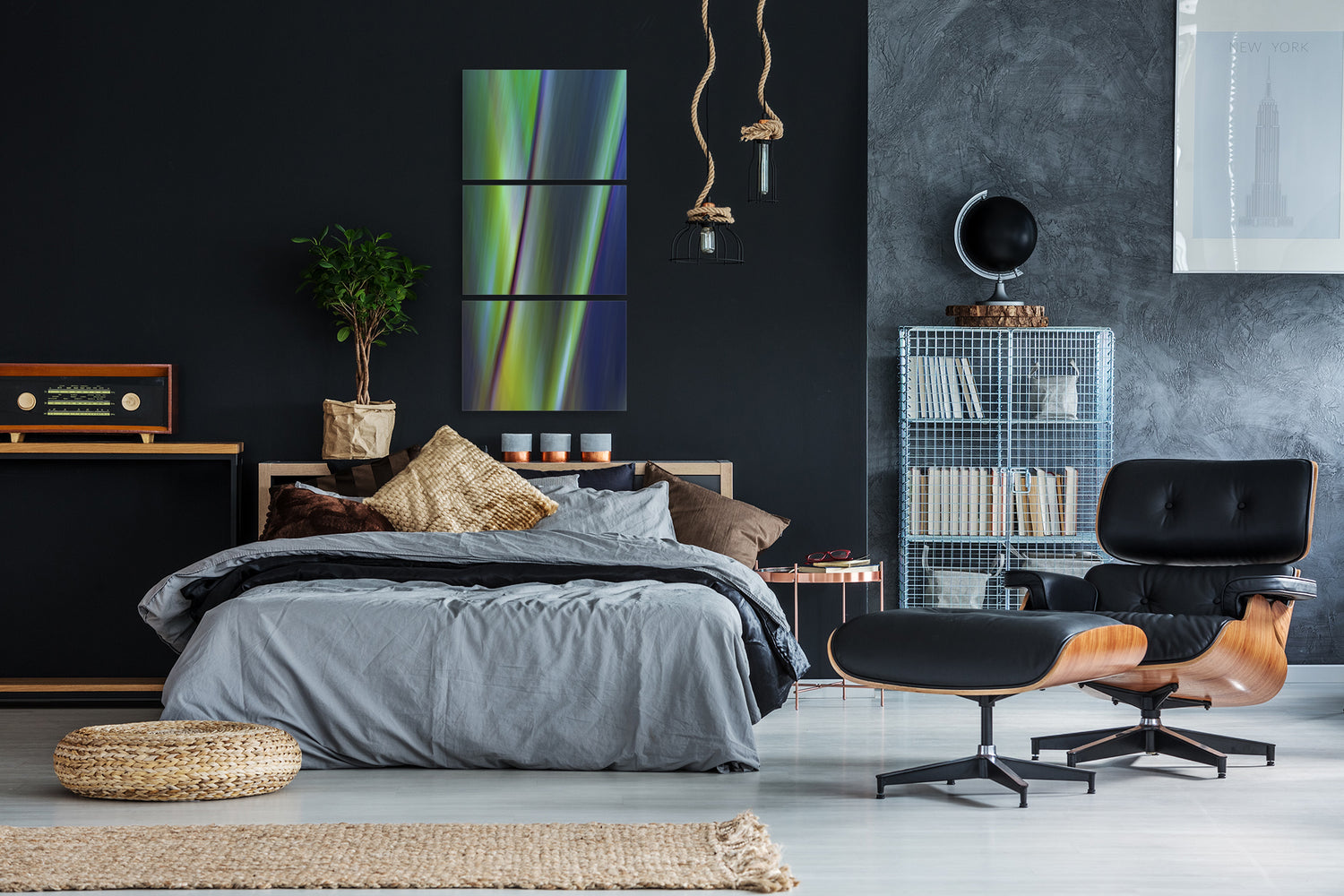 Modern bedroom with dark walls, a bed, and contemporary multi piece artwork.