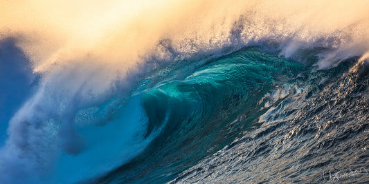 A powerful ocean wave breaking at sunset, capturing the essence of the product's thrilling experience of being on the water during sunset in Hawaii.