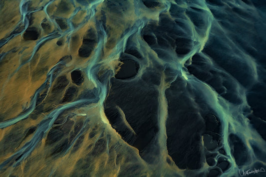 abstract photograph of sand dunes with a blue and yellow coloration