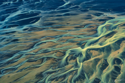 Aerial view of winding river systems on a sandy landscape