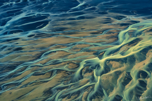 Aerial view of winding river systems on a sandy landscape
